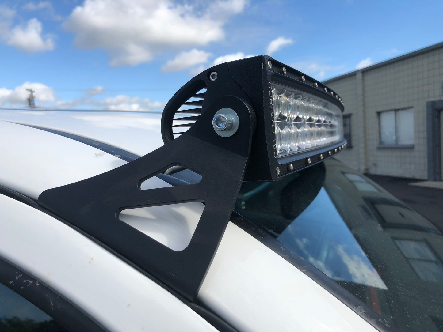 Close up Installed Cali Raised 52" Curved LED Light Bar Roof Brackets Kit | 2005-2023 Toyota Tacoma
